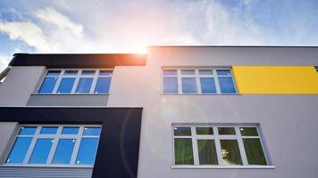 Multi-colored facades of the school with white window frames. photo