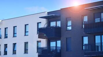 Modern apartment building in sunny day. Exterior, residential house facade. Residential area with modern, new and stylish living block of flats. photo