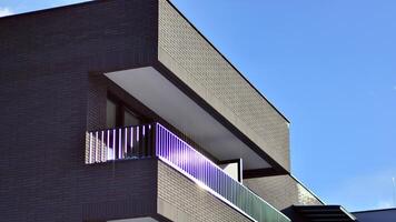 Modern apartment building in sunny day. Exterior, residential house facade. Residential area with modern, new and stylish living block of flats. photo