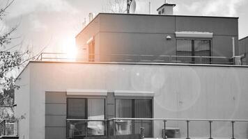 Fragment of the building's facade with windows and balconies. Modern apartment buildings on a sunny day. Facade of a modern residential building. Black and white. photo