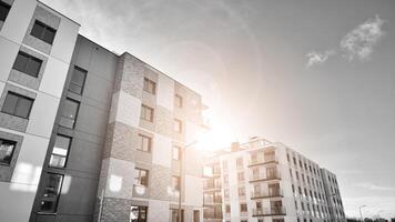 Fragment of the building's facade with windows and balconies. Modern apartment buildings on a sunny day. Facade of a modern residential building. Black and white. photo