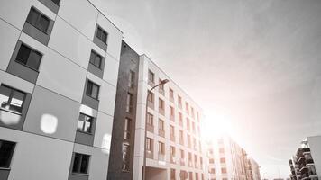 Fragment of the building's facade with windows and balconies. Modern apartment buildings on a sunny day. Facade of a modern residential building. Black and white. photo