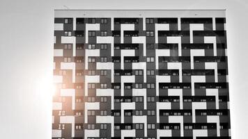 Fragment of the building's facade with windows and balconies. Modern apartment buildings on a sunny day. Facade of a modern residential building. Black and white. photo