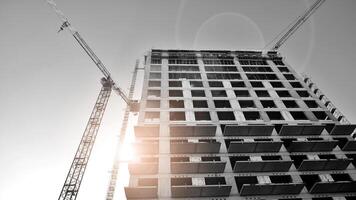 Fragment of the building's facade with windows and balconies. Modern apartment buildings on a sunny day. Facade of a modern residential building. Black and white. photo