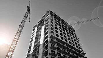 Fragment of the building's facade with windows and balconies. Modern apartment buildings on a sunny day. Facade of a modern residential building. Black and white. photo