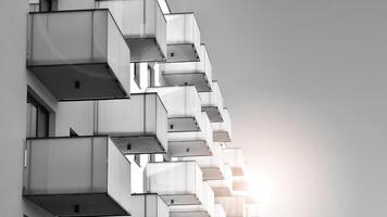 Fragment of the building's facade with windows and balconies. Modern apartment buildings on a sunny day. Facade of a modern residential building. Black and white. photo