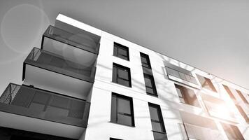 Fragment of a facade of a building with windows and balconies. Modern apartment buildings on a sunny day. Facade of a modern apartment building. Black and white. photo