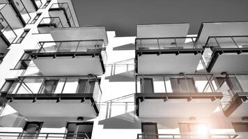 Fragment of a facade of a building with windows and balconies. Modern apartment buildings on a sunny day. Facade of a modern apartment building. Black and white. photo