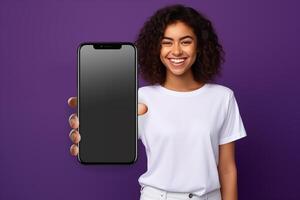 Woman in white t-shirt showing black blank screen smartphone on purple background photo