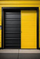 a black and yellow industrial building with a door photo