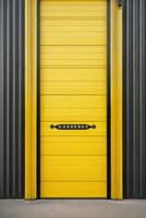 a black and yellow industrial building with a door photo