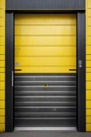 a black and yellow industrial building with a door photo
