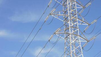 Electricity tower in high or medium voltage tower with clouds in the sky passing video