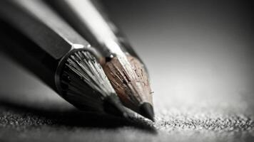 a close up of a pencil on a table black and white photo