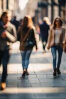 Defocused people walking in the street in motion blur photo