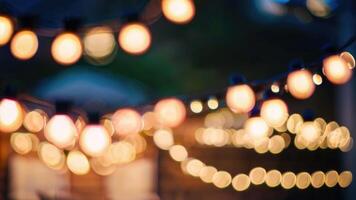 DDefocused restaurant with outdoor string lights on a blurred background photo