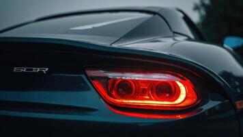 a close up of the tail light of a sports car photo