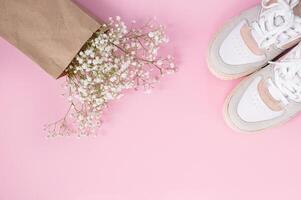 Bouquet of flowers and sneakers photo