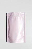 Pink storage bag with metallic texture with zip lock lock. Food bags made of aluminum foil, photo