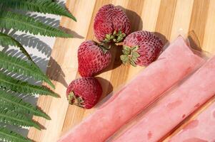 Ice cream in a bag with strawberries, sweet frozen homemade. Brazilian Dindin, chup-chup photo