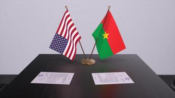 Burkina Faso and USA at negotiating table. Business and politics 3D illustration. National flags, diplomacy deal. International agreement photo