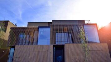 New single family house in a new development area. Residential home with modern wooden facade. photo