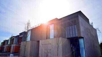 New single family house in a new development area. Residential home with modern wooden facade. photo