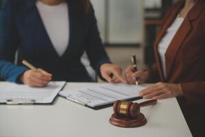 Lawyer, legal advisor, businessman brainstorming information on agreement details Business contracts in legal processing books for accuracy in contract documents. joint financial investment. photo