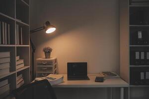 Laptop and paperwork on conference table photo