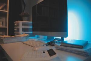 Laptop and paperwork on conference table photo