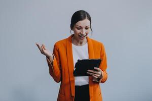 Smiling caucasian young woman girl freelancer student using digital tablet, having idea, pointing upwards on copyspace, surfing on social media, mobile applications, e-learning isolated in white photo