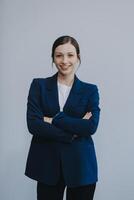 Successful young asian businesswoman in suit ready do business, cross arms confident and smiling. Female entrepreneur determined to win. Happy saleswoman talking to clients, white background photo