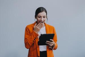 Smiling caucasian young woman girl freelancer student using digital tablet, having idea, pointing upwards on copyspace, surfing on social media, mobile applications, e-learning isolated in white photo