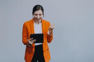 Smiling caucasian young woman girl freelancer student using digital tablet, having idea, pointing upwards on copyspace, surfing on social media, mobile applications, e-learning isolated in white photo