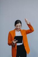 Smiling caucasian young woman girl freelancer student using digital tablet, having idea, pointing upwards on copyspace, surfing on social media, mobile applications, e-learning isolated in white photo