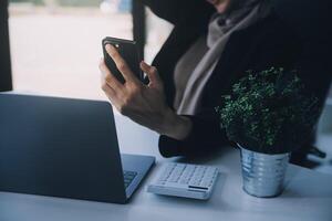 Shot of an attractive mature businesswoman working on laptop in her workstation. photo