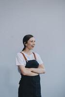 Cheerful beautiful Asian woman wearing jeans overalls with excited doing winner gesture with arms raised isolated on white background. photo