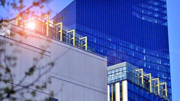 High rise building under construction. Installation of glass facade panels on a reinforced concrete structure. photo