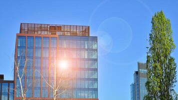 Eco building in modern city concept. Modern office building with the fresh green leaves. photo