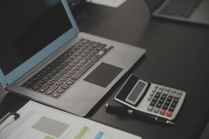 Laptop on a desk in an open financial office. photo