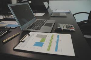 Laptop on a desk in an open financial office. photo