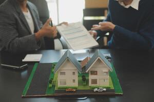 Team of architectures and businessmen discussing and brainstorming on floor plan modification for real estate investment and housing development project photo