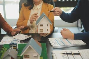 Team of architectures and businessmen discussing and brainstorming on floor plan modification for real estate investment and housing development project photo