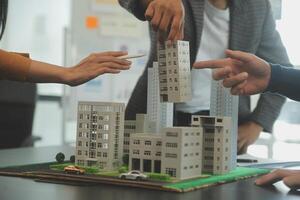 Team of architectures and businessmen discussing and brainstorming on floor plan modification for real estate investment and housing development project photo