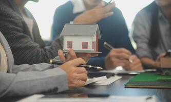 Team of architectures and businessmen discussing and brainstorming on floor plan modification for real estate investment and housing development project photo