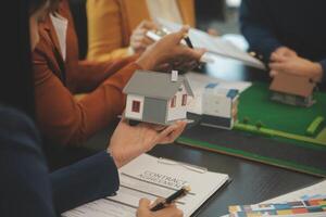 Team of architectures and businessmen discussing and brainstorming on floor plan modification for real estate investment and housing development project photo