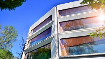 Eco architecture. Green tree and new residential building. Harmony of nature and modernity. Modern apartment building with new apartments in a green residential area. photo