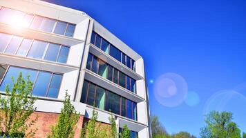 Eco architecture. Green tree and new residential building. Harmony of nature and modernity. Modern apartment building with new apartments in a green residential area. photo