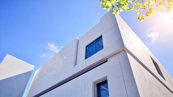 Sunlight and shadow on surface of white Concrete Building wall against blue sky background, Geometric Exterior Architecture in Minimal Street photography style photo