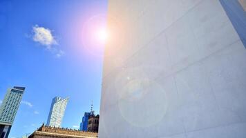 Sunlight and shadow on surface of white Concrete Building wall against blue sky background, Geometric Exterior Architecture in Minimal Street photography style photo